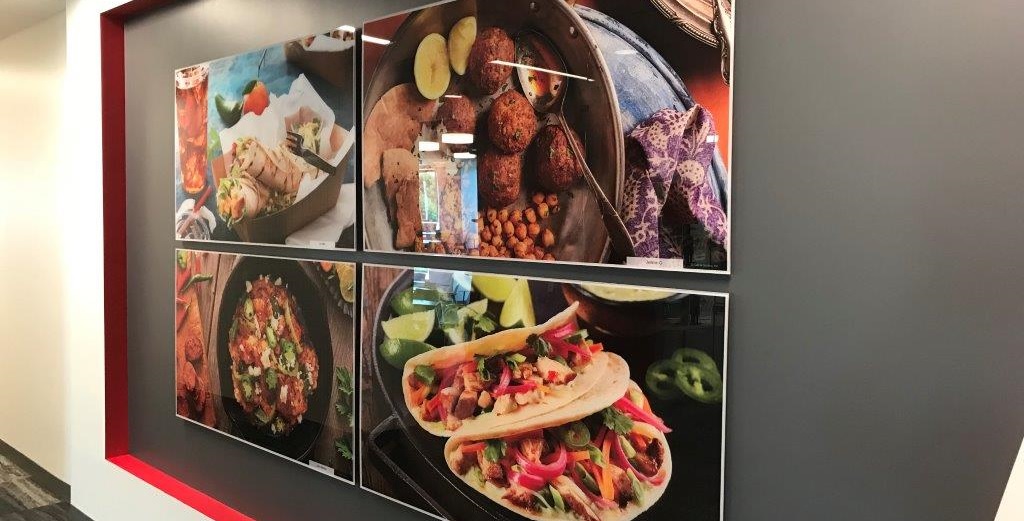 Photographic prints of food options from UniPro Food printed and mounted 2nd surface to Acrylic in an office hallway